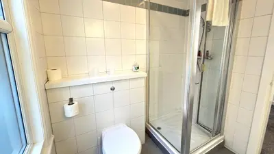 a bathroom with a toilet and a shower at Lord Nelson Hotel-Lime Street Station Liverpool by Compass Hospitality in Liverpool