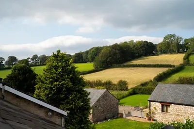 a view of a field from a house at Clare's Cottage Near Cartmel - Dog Friendly, Homely, Aga, Log Burners, Disney Plus & Netflix in Holker