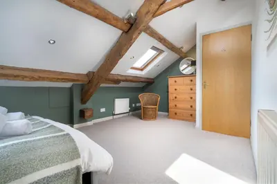 a bedroom with green walls and a wooden ceiling at Clare's Cottage Near Cartmel - Dog Friendly, Homely, Aga, Log Burners, Disney Plus & Netflix in Holker