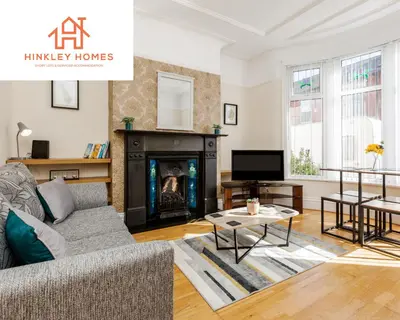 a living room with a couch and a fireplace at Supersized 5bed - Free parking - 8 beds - Anfield - By Hinkley Homes Short Lets & Serviced Accommodation in Liverpool