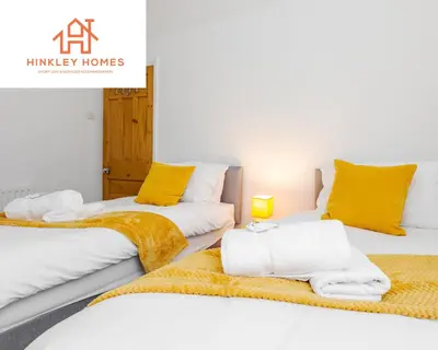 two beds in a room with yellow pillows at Supersized 5bed - Free parking - 8 beds - Anfield - By Hinkley Homes Short Lets & Serviced Accommodation in Liverpool