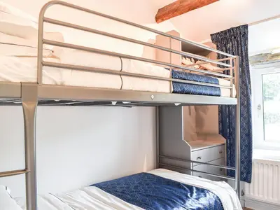 a bedroom with bunk beds in a dorm room at Thornton Cottage in Grizebeck