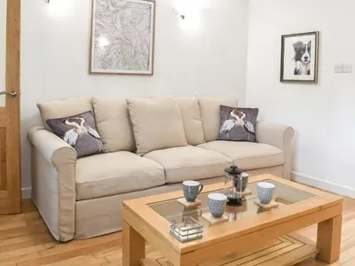 a living room with a couch and a coffee table at Thornton Cottage in Grizebeck