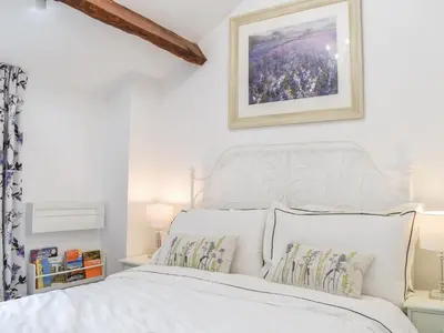 a white bed with white sheets and pillows at Thornton Cottage in Grizebeck