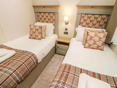 two twin beds in a room with at Coniston View 9 in Carnforth