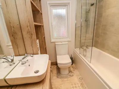 a bathroom with a sink and a toilet and a shower at Coniston View 9 in Carnforth
