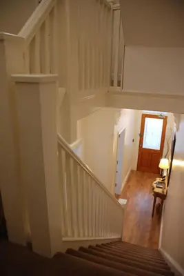 a staircase in a house with a stair case at Wendover Guest House in Bolton