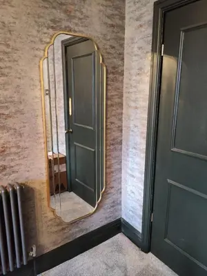 a mirror on a wall next to a door at The Ribchester Arms in Blackburn