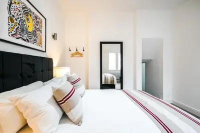 a bedroom with a large white bed with white pillows at The Anfield Hotel in Liverpool