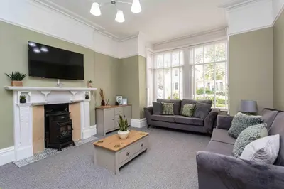a living room with a couch and a fire place at Orchard Lodge in Lytham St Annes