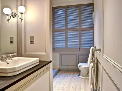 a white bathroom with a sink and a toilet at Bay Villa in Grange Over Sands