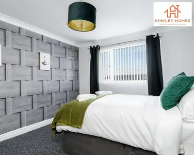 a bedroom with a bed and a brick wall at Spacious 3 bedroom house with wifi and car parking By Hinkley Homes Short Lets & Serviced Accommodation in Waterloo