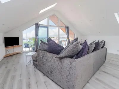 a living room with a couch with pillows on it at Sea La Vie in Lytham St Annes