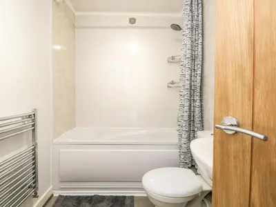 a bathroom with a toilet and a bath tub at Coach House in Carnforth