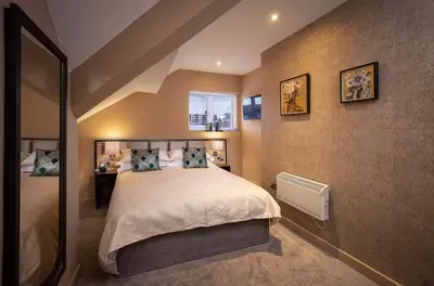 a bedroom with a large bed in a room at Coral Boutique Apartment 3 in Blackpool