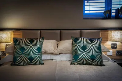 a bedroom with a bed with two pillows on it at Coral Boutique Apartment 3 in Blackpool
