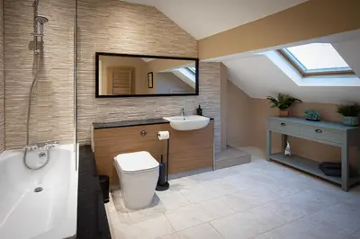 a bathroom with a tub and a sink and a toilet at Coral Boutique Apartment 3 in Blackpool