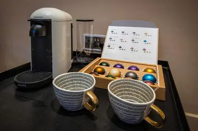 two cups sitting on a counter next to a box of balls at Coral Boutique Apartment 3 in Blackpool