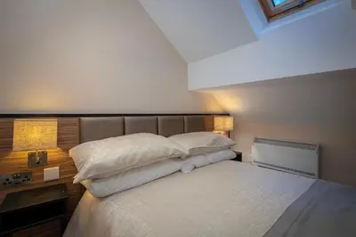 a bedroom with a bed with two pillows on it at Coral Boutique Apartment 3 in Blackpool