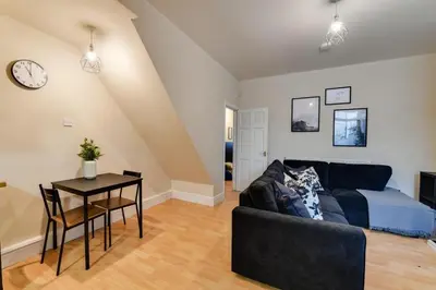 a living room with a couch and a table at Poppy's Pad - Winchester Road in Liverpool