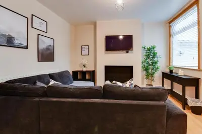 a living room with a couch and a fireplace at Poppy's Pad - Winchester Road in Liverpool