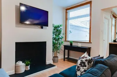 a living room with a couch and a fireplace at Poppy's Pad - Winchester Road in Liverpool