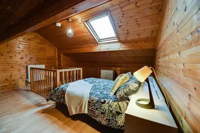 a bedroom with a bed in a wooden cabin at Poppy's Pad - Winchester Road in Liverpool