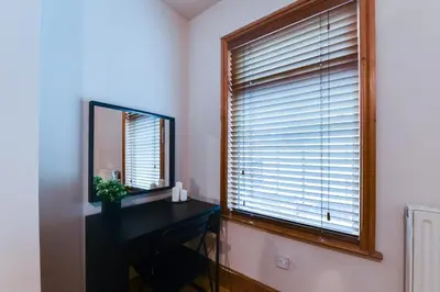 a room with a mirror and a desk and a window at Poppy's Pad - Winchester Road in Liverpool