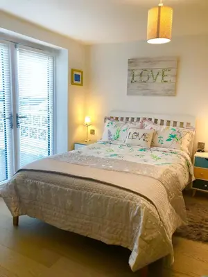 a bedroom with a bed and a window at Sunsets, Sandylands Prom Morecambe in Morecambe
