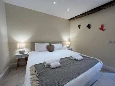 a bedroom with a large bed with towels on it at Spring Cottage in Ulverston