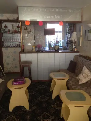 a living room with a couch and two stools at The Lanes in Blackpool