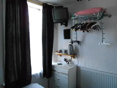 a bedroom with a bed and a tv and a window at The Lanes in Blackpool