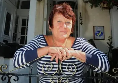 a woman sitting in front of a fence at The Lanes in Blackpool
