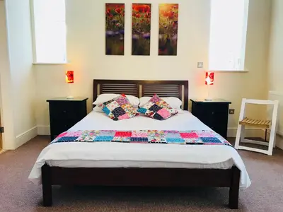 a bedroom with a bed with pillows on it at The Shelbourne in Southport