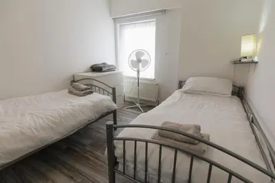 a bedroom with two beds and a window at Windsor Stays 2 in Liverpool