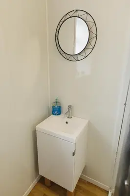 a bathroom with a white sink and a mirror at Windsor Stays 2 in Liverpool