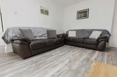 two brown leather couches in a living room at Windsor Stays 2 in Liverpool