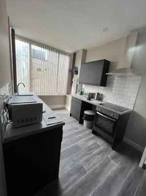 a kitchen with a stove and a counter top at Velveteen by The V Group in Blackpool