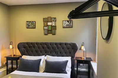 a bedroom with a bed with two night stands and two lamps at Velveteen by The V Group in Blackpool