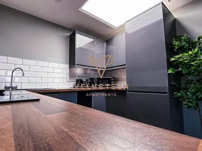 a kitchen with a wooden counter top in a room at Velveteen by The V Group in Blackpool