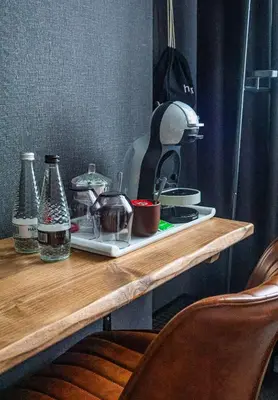 a counter top with a coffee maker and bottles on it at 24 Catharine Street Hotel in Liverpool
