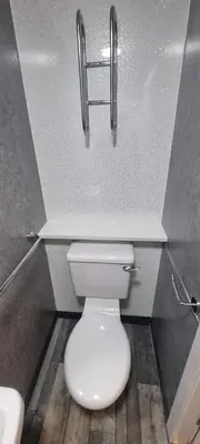 a bathroom with a white toilet in a stall at The Dudley Hotel in Blackpool