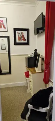 a room with a vanity with a mirror and a television at The Dudley Hotel in Blackpool