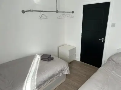 a bedroom with a bed and a black door at Windsor stays 1 in Liverpool