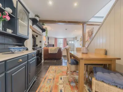 a kitchen with a table and a dining room at Mop Fair Sunny Garden Town Centre - Pass the Keys in Ulverston