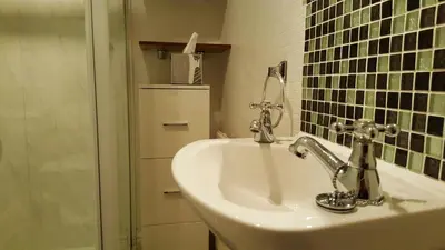 a bathroom with a sink and a shower at Gabrielles in Blackpool