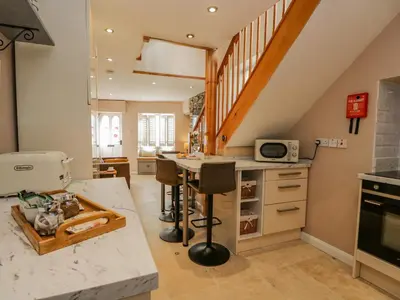 a kitchen with a counter and a kitchen island at Endgill Cottage in Ulverston