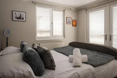 a bedroom with a bed with two pillows at Lakeland Lodge in Carnforth