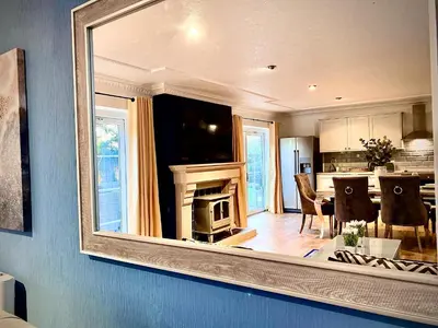 a living room with a mirror on the wall at Beautiful Hot Tub Suite in Lytham St Annes in Lytham St Annes