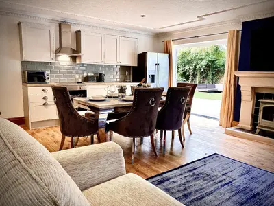 a living room with a kitchen with a table and chairs at Beautiful Hot Tub Suite in Lytham St Annes in Lytham St Annes